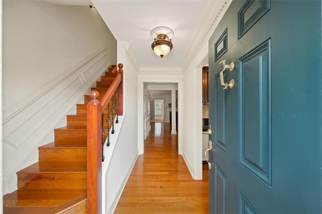 interior space with ornamental molding and light wood-type flooring