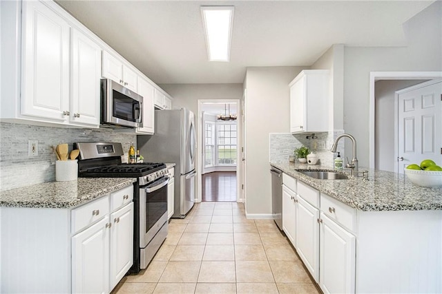 3710 Ridgefair Dr, Cumming, GA 30040 - kitchen featuring appliances with stainless steel finishes, backsplash, light tile patterned floors, and white cabinets
