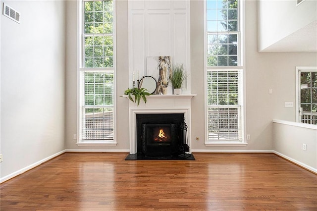 3710 Ridgefair Dr, Cumming, GA 30040 - living area featuring wood finished floors, plenty of natural light, and a fireplace with flush hearth