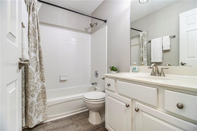 3710 Ridgefair Dr, Cumming, GA 30040 - bathroom featuring wood finished floors, shower / bath combo with shower curtain, vanity, and a textured ceiling