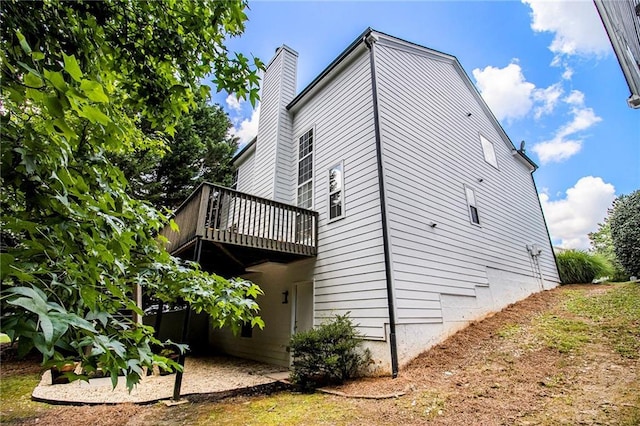 3710 Ridgefair Dr, Cumming, GA 30040 - view of home's exterior with a deck and a chimney