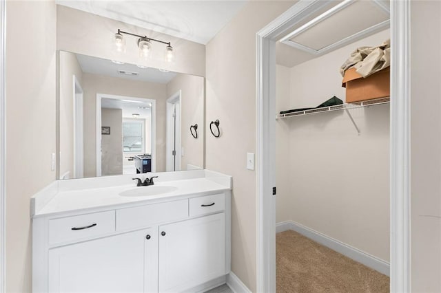 3875 Valley View Ct, Gainesville, GA 30501 - bathroom featuring a walk in closet, vanity, and baseboards
