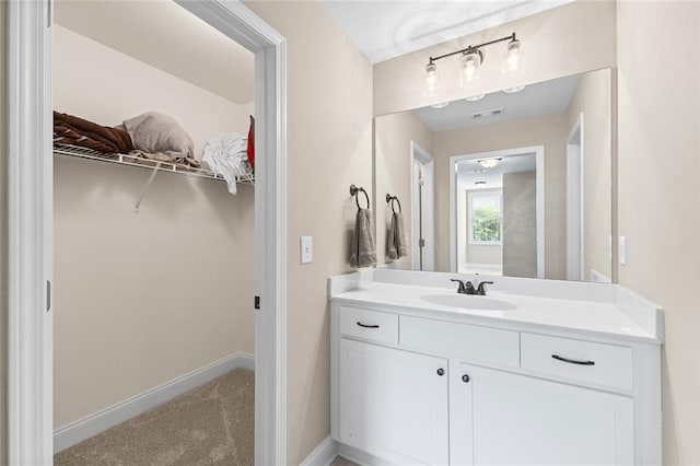 3875 Valley View Ct, Gainesville, GA 30501 - bathroom featuring vanity, a spacious closet, and baseboards
