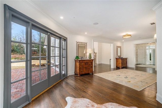 doorway with visible vents, ornamental molding, french doors, and wood finished floors