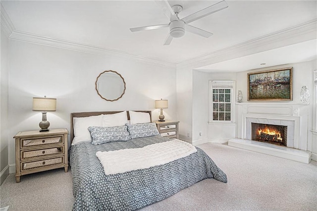 bedroom featuring baseboards, a fireplace, ceiling fan, crown molding, and carpet flooring