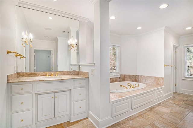 bathroom featuring a wealth of natural light, vanity, a jetted tub, and crown molding