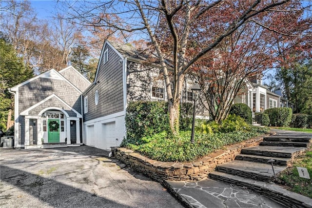 view of home's exterior featuring an attached garage and driveway