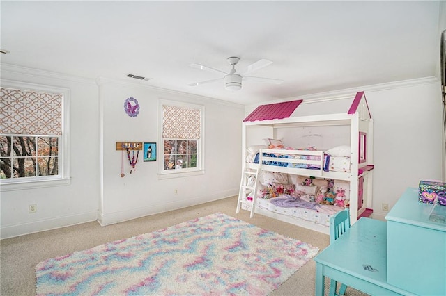 bedroom with crown molding, multiple windows, visible vents, and carpet floors