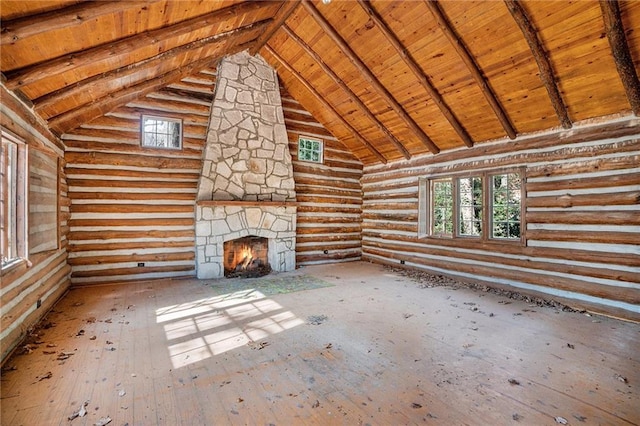 unfurnished living room featuring a stone fireplace, beam ceiling, wood ceiling, and high vaulted ceiling