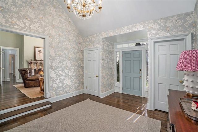 entrance foyer featuring wood finished floors, baseboards, wallpapered walls, an inviting chandelier, and vaulted ceiling