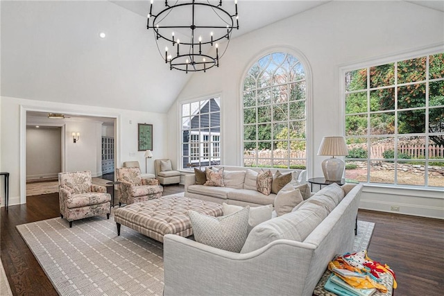 sunroom with vaulted ceiling, a healthy amount of sunlight, and a chandelier