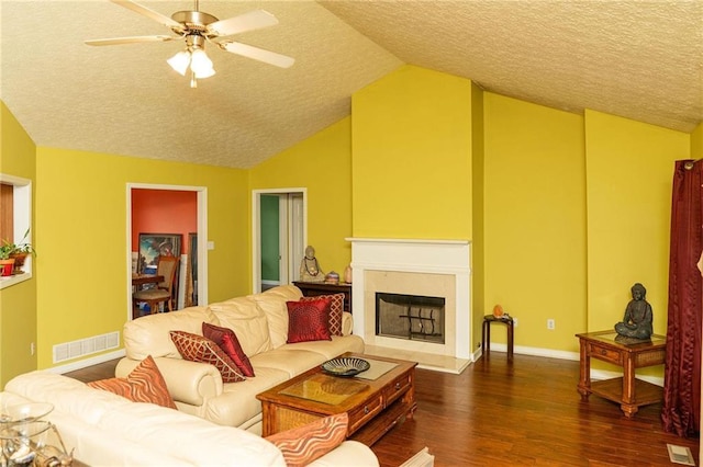68 Paradise Pointe, Douglasville, GA 30134 - living room featuring a textured ceiling, vaulted ceiling, dark wood finished floors, ceiling fan, and baseboards