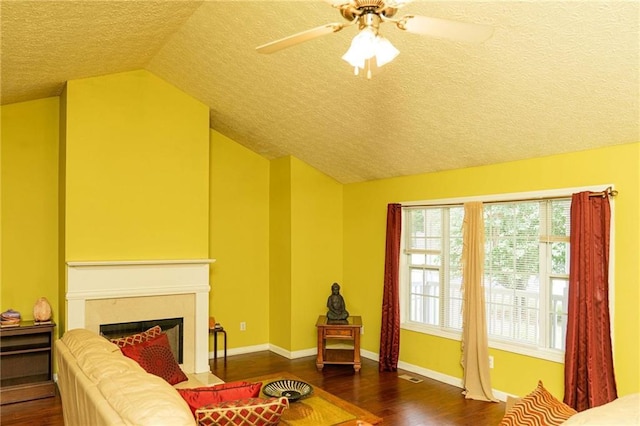 68 Paradise Pointe, Douglasville, GA 30134 - living area with a textured ceiling, lofted ceiling, wood finished floors, a ceiling fan, and a fireplace