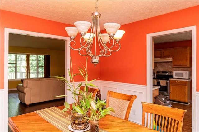 68 Paradise Pointe, Douglasville, GA 30134 - dining area with a chandelier, wainscoting, wood finished floors, and a textured ceiling