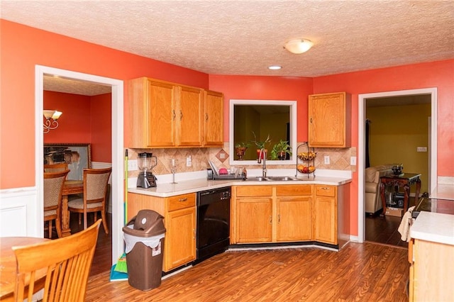 68 Paradise Pointe, Douglasville, GA 30134 - kitchen with a sink, dishwasher, light countertops, wood finished floors, and a textured ceiling