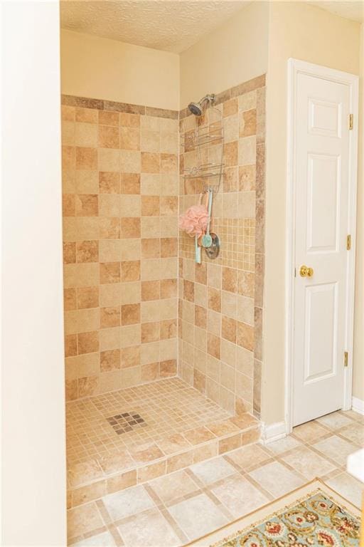 68 Paradise Pointe, Douglasville, GA 30134 - bathroom featuring a tile shower, a textured ceiling, and tile patterned flooring