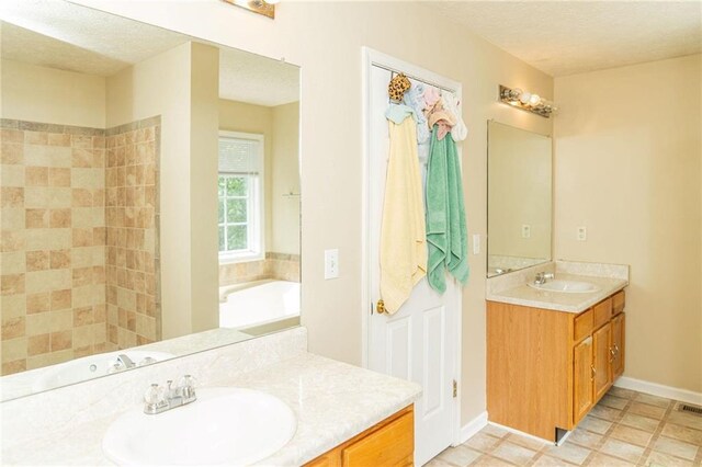 68 Paradise Pointe, Douglasville, GA 30134 - bathroom with a textured ceiling, vanity, and a bath