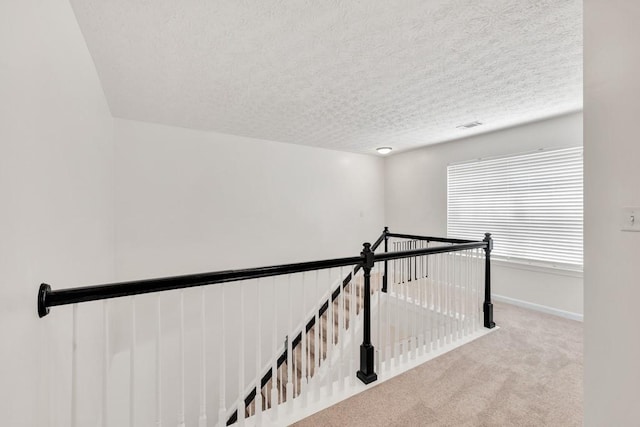 1186 Hawthorn Ln, Grayson, GA 30017 - corridor featuring an upstairs landing, carpet, a textured ceiling, and baseboards