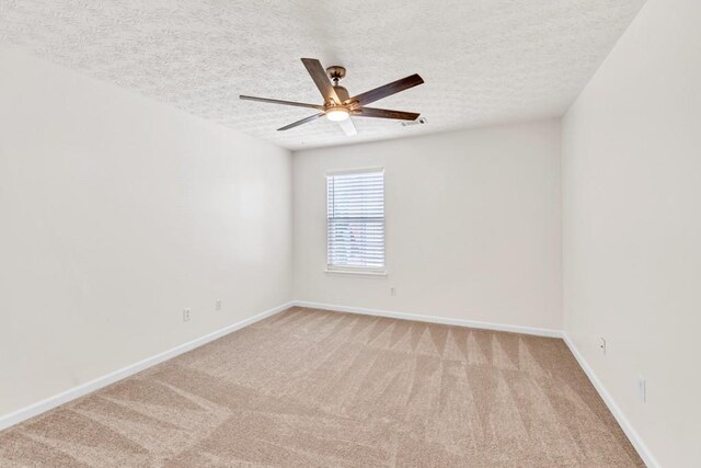 1186 Hawthorn Ln, Grayson, GA 30017 - spare room with ceiling fan, light colored carpet, a textured ceiling, and baseboards