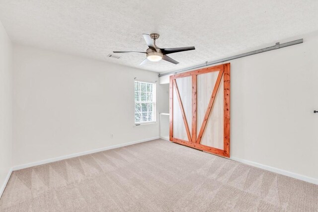 1186 Hawthorn Ln, Grayson, GA 30017 - spare room with light colored carpet, baseboards, ceiling fan, and a textured ceiling