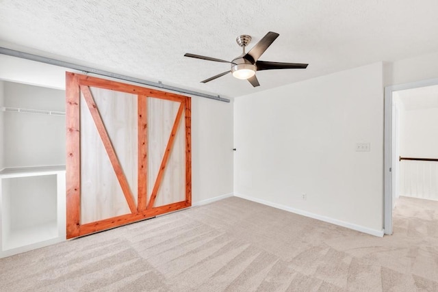 1186 Hawthorn Ln, Grayson, GA 30017 - unfurnished bedroom featuring carpet floors, ceiling fan, baseboards, and a textured ceiling