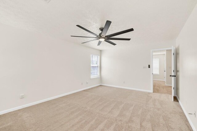 1186 Hawthorn Ln, Grayson, GA 30017 - unfurnished room featuring a ceiling fan, baseboards, and light carpet