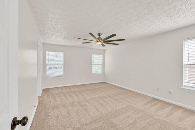 1186 Hawthorn Ln, Grayson, GA 30017 - empty room featuring a ceiling fan, light colored carpet, a textured ceiling, and baseboards