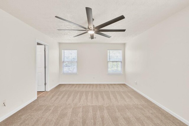 1186 Hawthorn Ln, Grayson, GA 30017 - empty room with light carpet, a ceiling fan, a textured ceiling, and baseboards