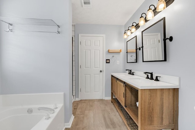 1186 Hawthorn Ln, Grayson, GA 30017 - bathroom with a garden tub, double vanity, wood finished floors, and baseboards