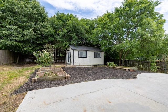 1186 Hawthorn Ln, Grayson, GA 30017 - view of outdoor structure featuring a garden and a fenced backyard