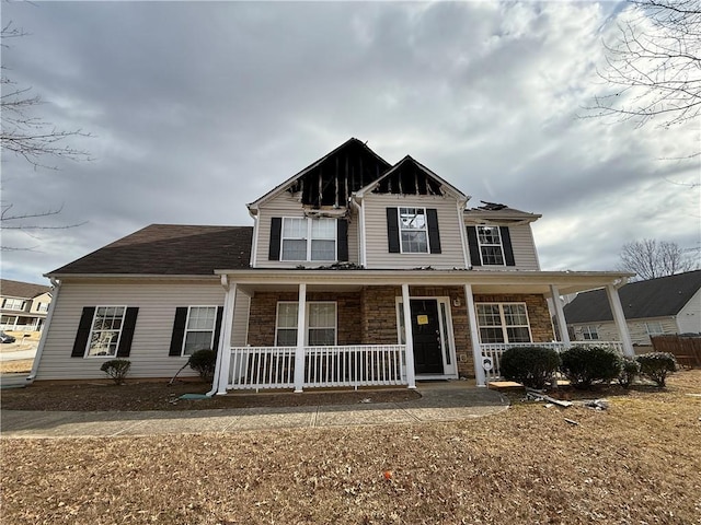 view of front of home featuring a porch and stone siding