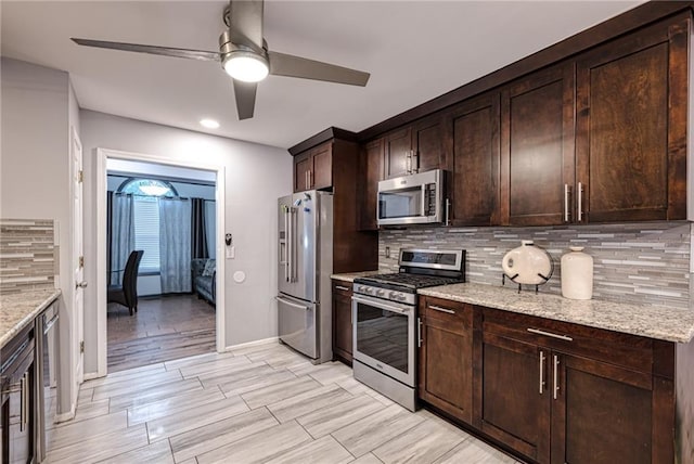 kitchen featuring tasteful backsplash, dark brown cabinets, ceiling fan, and appliances with stainless steel finishes