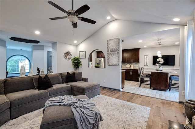 living room featuring recessed lighting, a ceiling fan, light wood-style flooring, and lofted ceiling