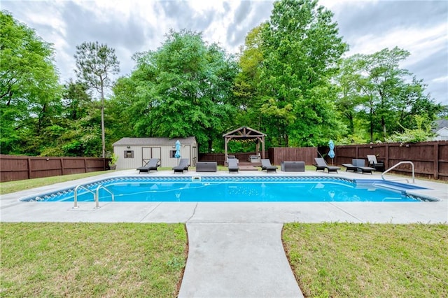 view of pool with a gazebo, a fenced backyard, an outbuilding, and a lawn