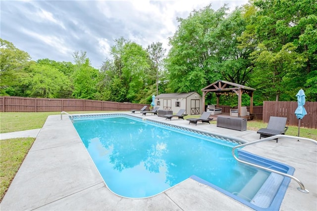 view of pool featuring a fenced backyard, a shed, and a patio area