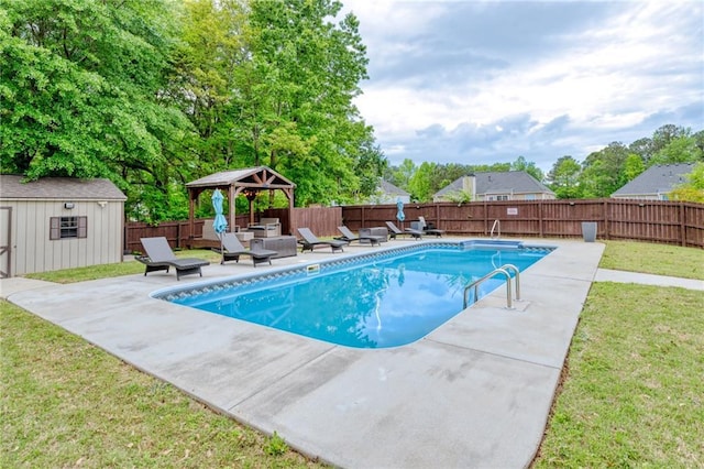 view of swimming pool with a fenced in pool, a gazebo, a patio area, an outbuilding, and a fenced backyard