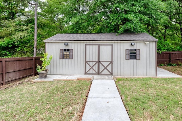 view of shed with a fenced backyard