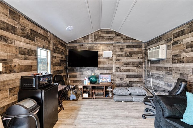 living room with wood walls, wood finished floors, a wall mounted AC, and vaulted ceiling