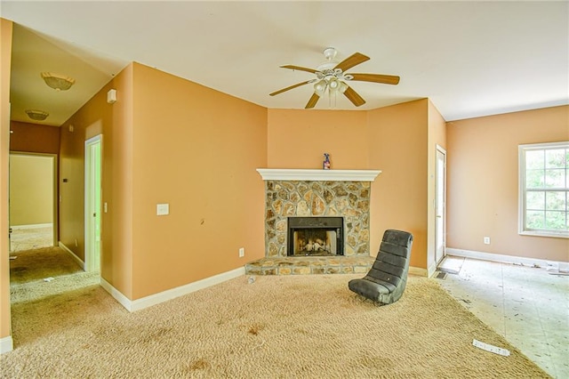 unfurnished living room featuring a fireplace and ceiling fan