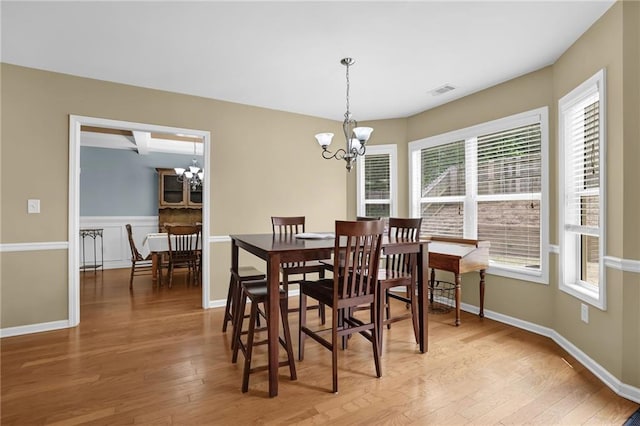 1267 Castleberry Dr, Buford, GA 30518 - dining space featuring a chandelier, light wood-style floors, and baseboards
