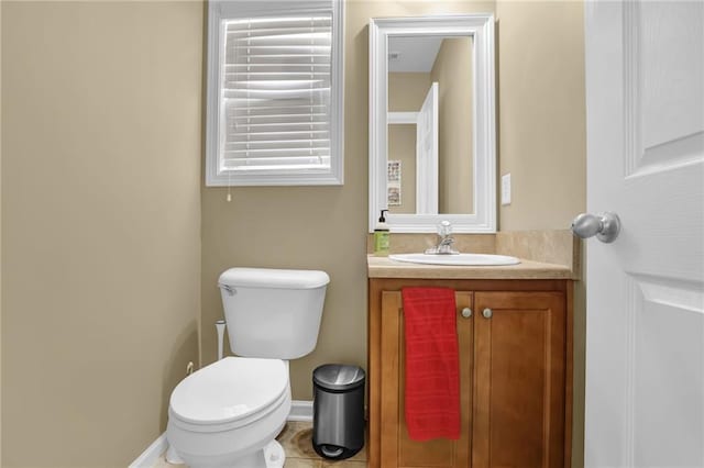 1267 Castleberry Dr, Buford, GA 30518 - half bathroom featuring toilet, vanity, baseboards, and tile patterned flooring