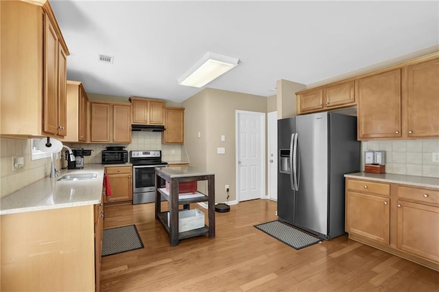 1267 Castleberry Dr, Buford, GA 30518 - kitchen with stainless steel appliances, a sink, decorative backsplash, and light wood-style flooring