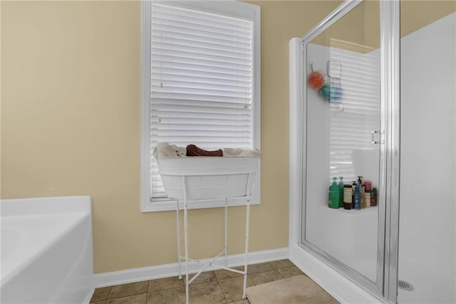 1267 Castleberry Dr, Buford, GA 30518 - full bathroom with baseboards, a stall shower, tile patterned flooring, and a bath