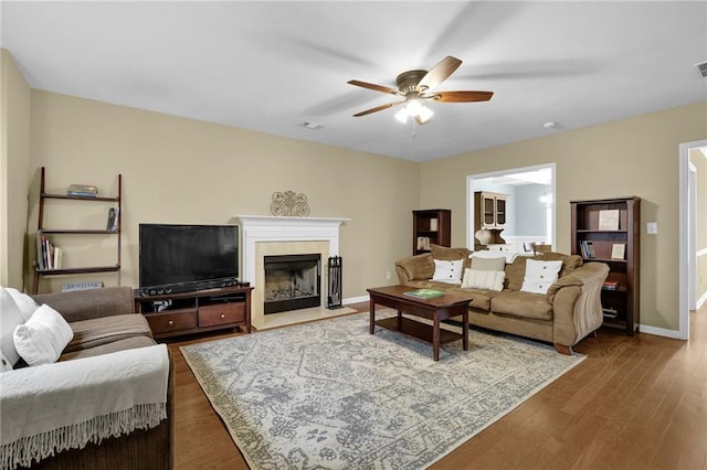 1267 Castleberry Dr, Buford, GA 30518 - living area featuring a ceiling fan, a fireplace with flush hearth, wood finished floors, and baseboards