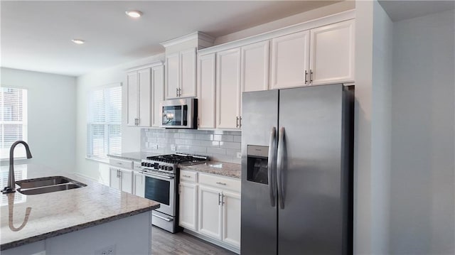 kitchen featuring sink, stainless steel appliances, and white cabinetry