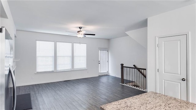 foyer entrance with ceiling fan and dark hardwood / wood-style floors