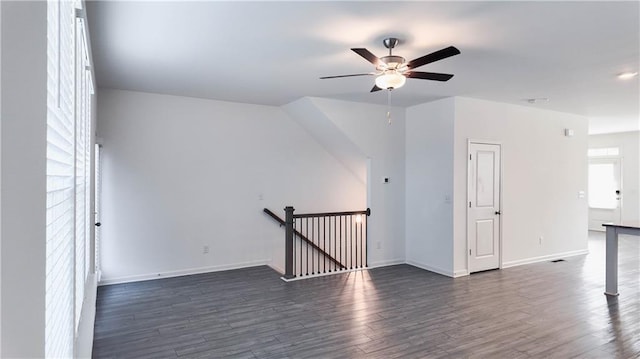 empty room with ceiling fan and dark hardwood / wood-style floors