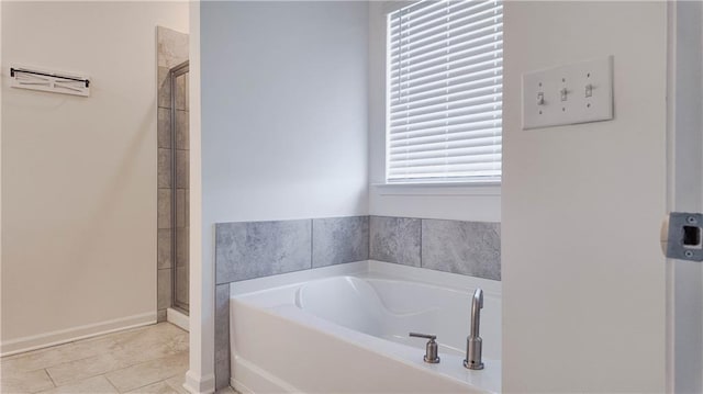bathroom featuring plus walk in shower and tile patterned floors