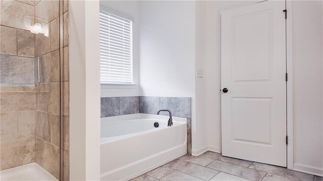 bathroom with independent shower and bath and tile patterned flooring