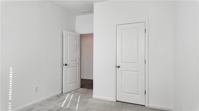 unfurnished bedroom featuring light carpet
